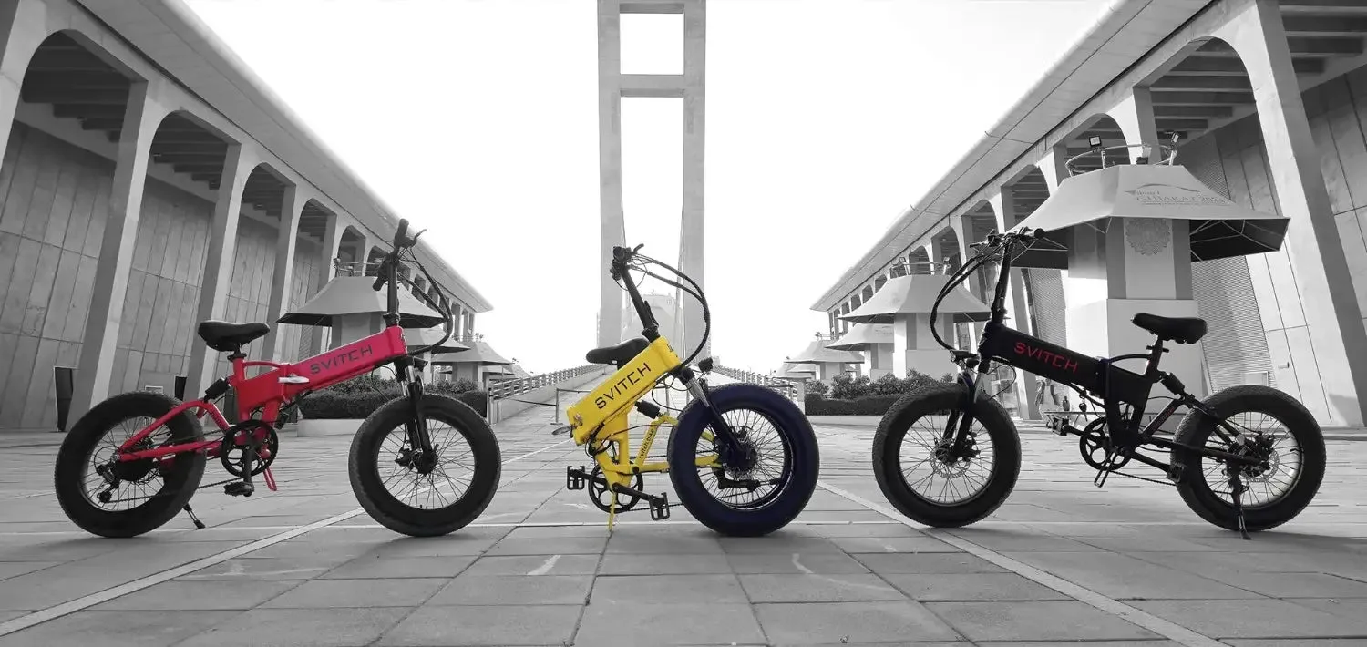 Three Svitch folding electric bicycles in red, yellow and black